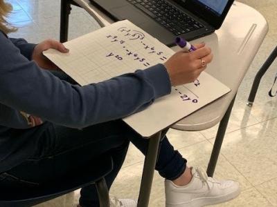 Photo of student Independently solving an equation. 